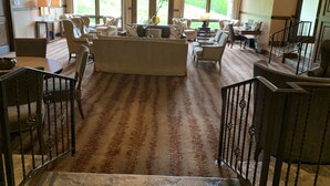 A spacious lobby with a large seating area, a chandelier, and large windows offering a view of the outdoors. - Beaver Creek Ski-in/Ski-out Condo (Avon)