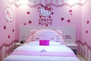 A pink-themed bedroom with a Hello Kitty design, a bed with pink and white bedding, and a nightstand with a phone. - Yiyue Express Hotel (Guangzhou)