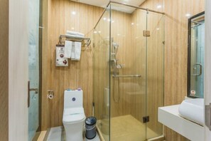 A modern bathroom with a glass-enclosed shower, a toilet, and a sink. - Yiyue Express Hotel (Guangzhou)