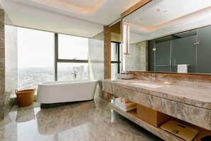 A modern bathroom with a large bathtub, a marble vanity, and a city view. - Lindao Holiday Inn (Chengdu)