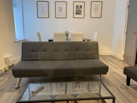 Apartment, Multiple Beds | Living area | 30-inch TV with digital channels