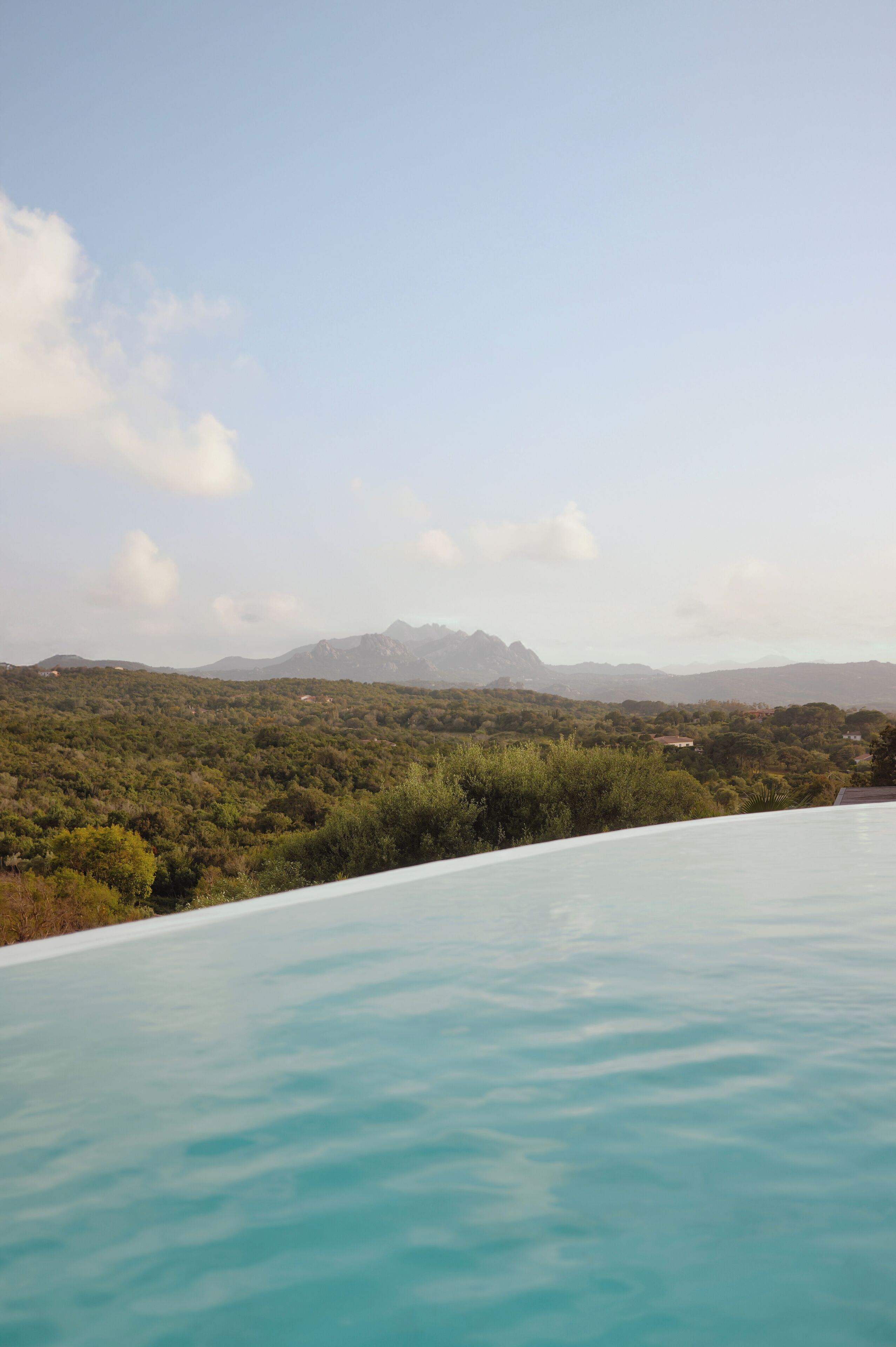 A pool with a view of a mountainous landscape.