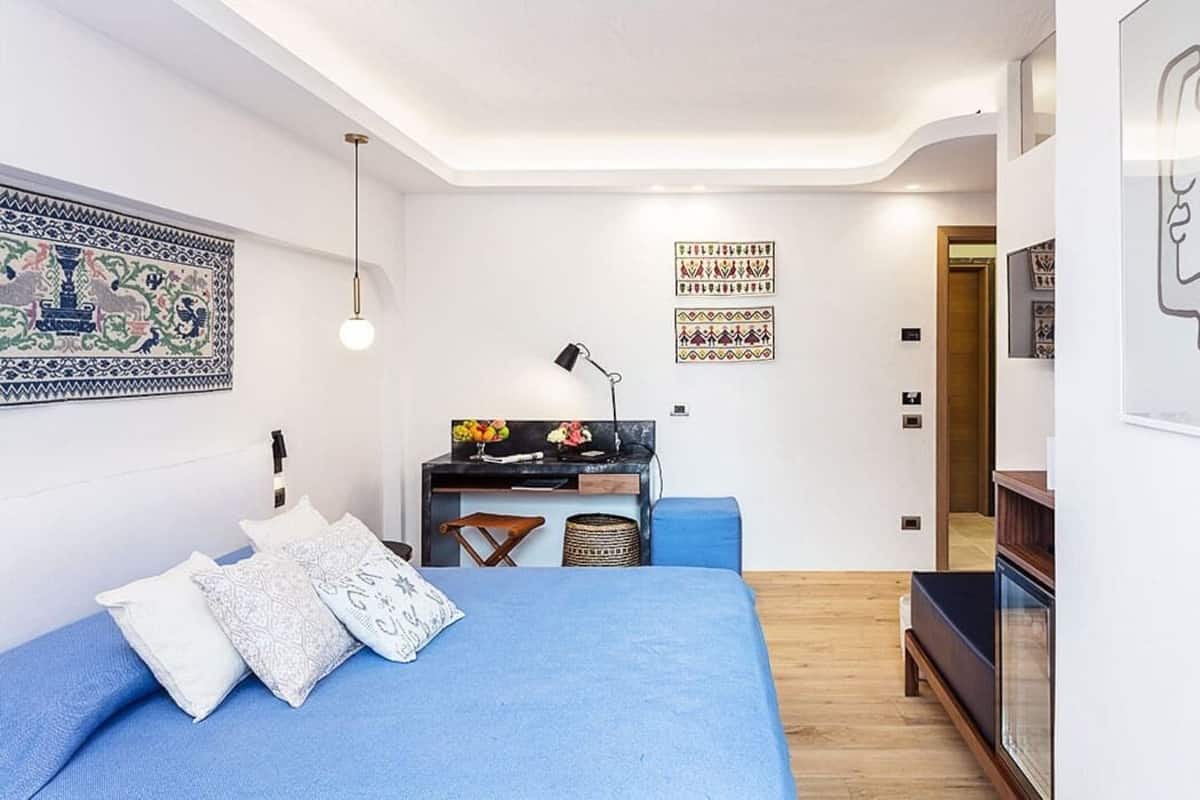 A compact bedroom with a bed, a desk, and a chair.