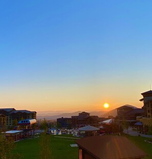 A residential area with a clear sky and the sun setting in the distance.