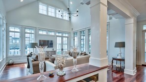 A spacious living room with a wooden coffee table, a sofa, and a TV.