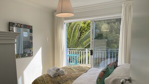 A bedroom with a bed, a window with a view of a balcony, and a mirror on the wall. - TREETOPS PENTHOUSE ROSE BAY, SYDNEY 3 BEDROOMS LOUNGE KITCHEN/GARAGE PARKING (Rose Bay North)