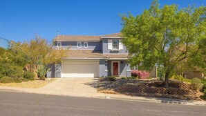 A two-story house with a garage, surrounded by landscaping and trees. - Nice remodeled House for rent in West side of Palmdale (Palmdale)