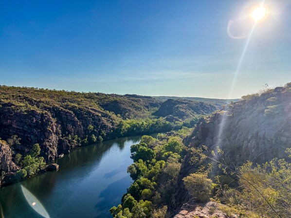 A river winding through a canyon with rocky cliffs and sparse vegetation.