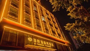 A multi-story building with illuminated signage and a visible entrance.