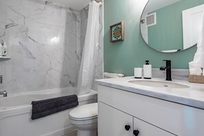 Combined shower/tub, hair dryer, towels, soap