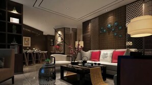 A modern living room with a sofa, coffee table, and decorative items.