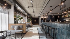 A modern bar area with seating, bar stools, and a bar counter.