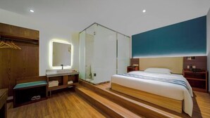 A modern hotel room with a wooden floor, a large bed, a glass shower enclosure, a bedside table, and a wall-mounted mirror. - HengYangYi’nian Yuexiang Hotel (Hengyang)