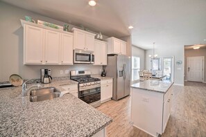 Enjoy cooking in this well-equipped kitchen with a gas stove, refrigerator, and microwave.