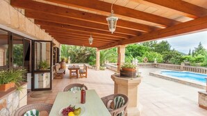An outdoor patio with a pool, wooden pergola, wicker furniture, and potted plants. - Private pool and 1.7km to Mallorca’s Beaches! (Palma de Mallorca)