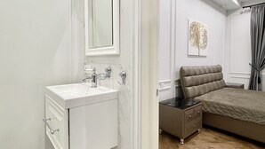 A modern bedroom with a large bed, a bedside table, and a built-in wardrobe. - Home Apart Sverdlova str 26 (Minsk)