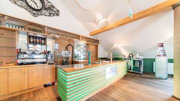 A modern kitchen with wooden cabinets, a central island, and a clock on the wall.