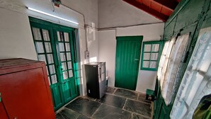A room with a red cabinet, a black refrigerator, and green doors. - Pre Independence 2 BHK Bungalow,dalhousie,himachal (Dalhousie)