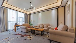 A modern living room with a sofa set, a coffee table, and a lamp. - Yuting Impression Hotel (Zhongjiang)