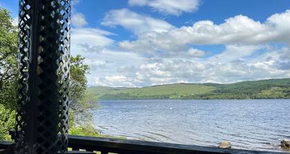 Charming loch side log cabin with hot tub & stunning views across loch