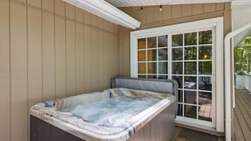 A hot tub with a view of a deck and outdoor area.