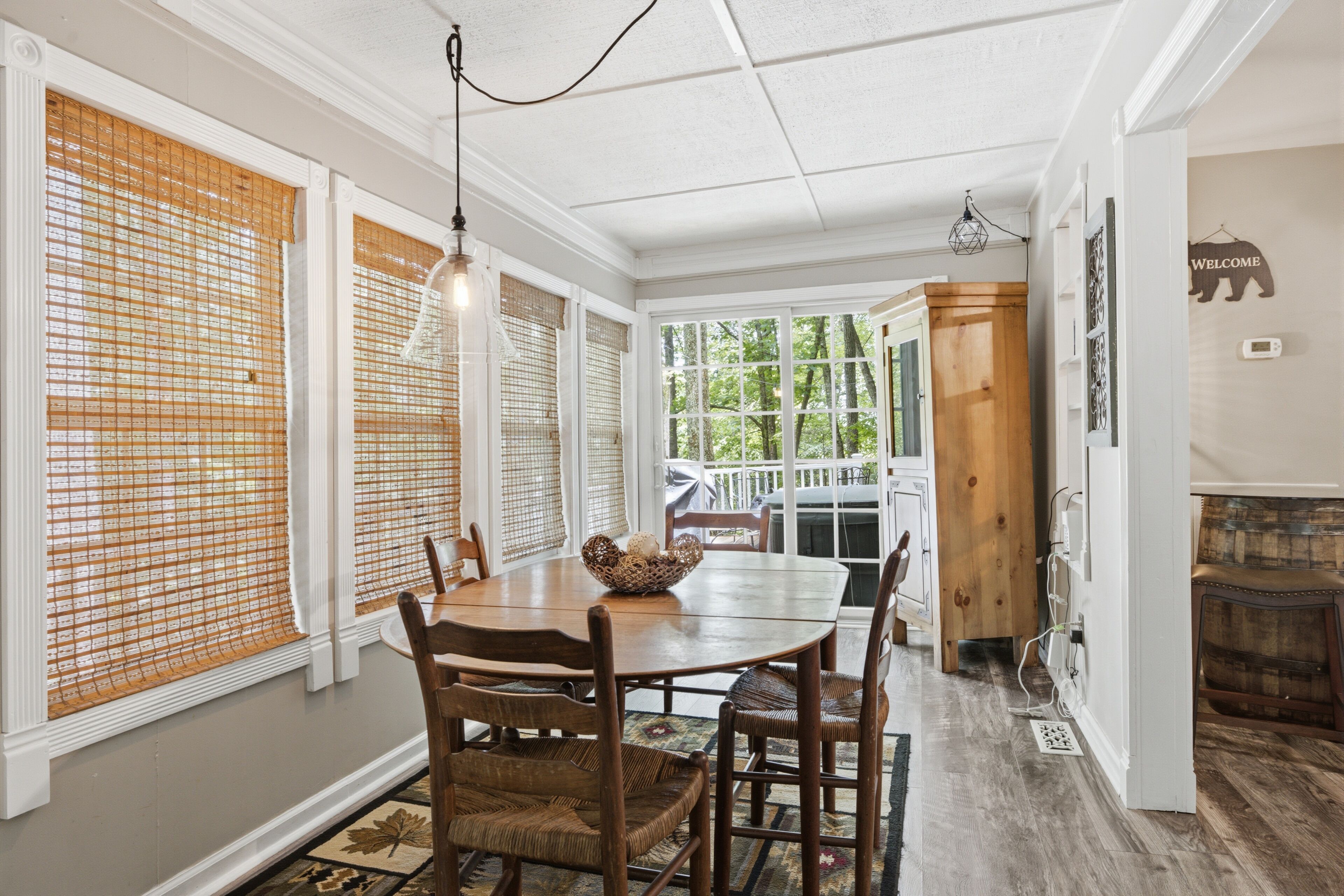 A dining area with a wooden table, chairs, and a decorative bowl.