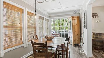 A dining area with a wooden table, chairs, and a decorative bowl.