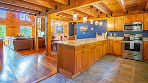 A spacious kitchen with wooden cabinets, granite countertops, and stainless steel appliances.