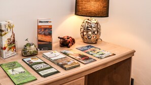 A reception desk with a lamp, brochures, a Welcome sign, and a Welcome to Southport sign. - Bella Vita (Southport)