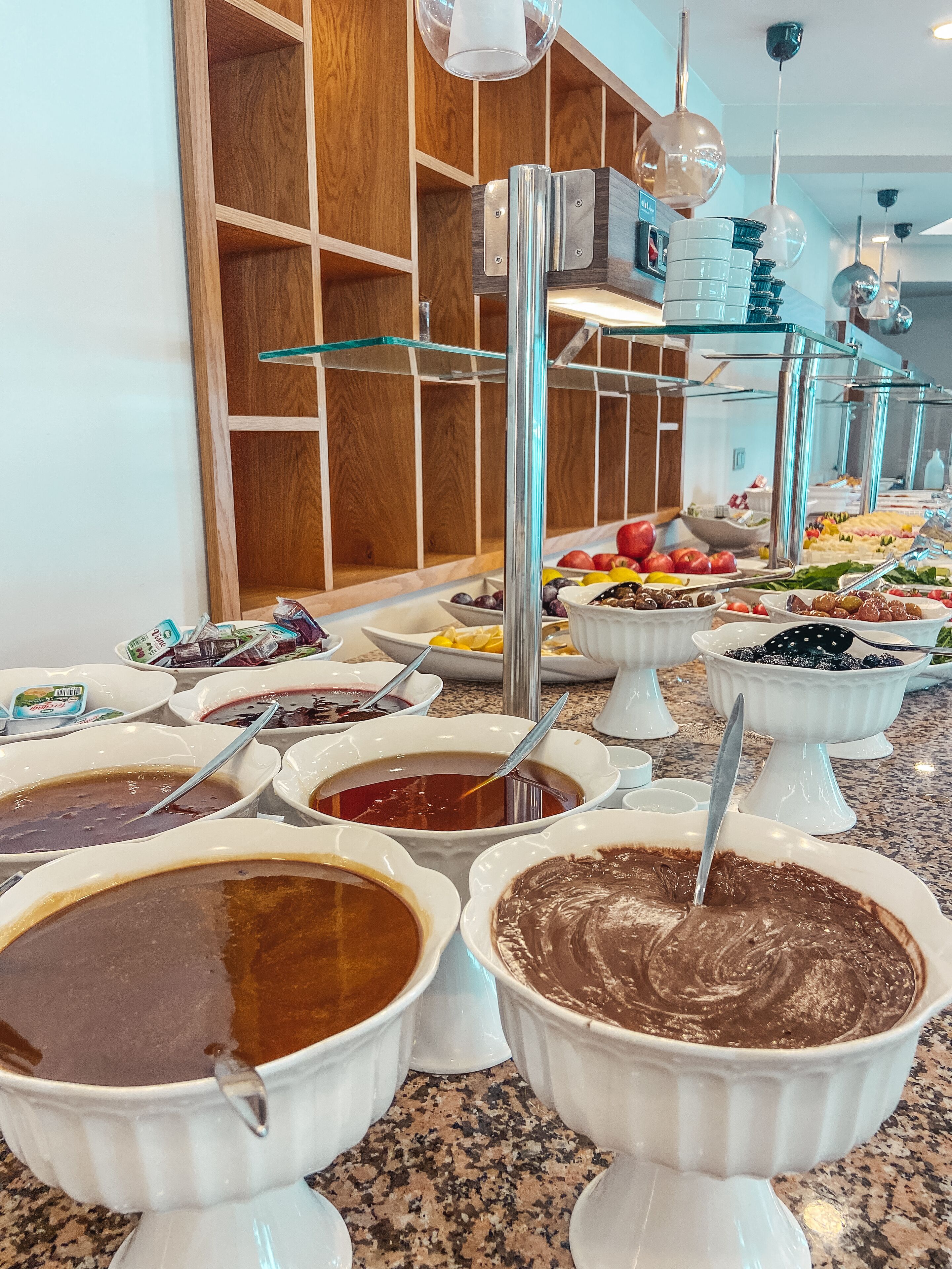 A buffet with various food items and beverages.