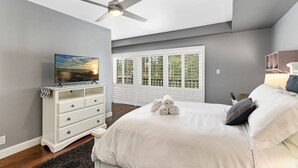 A bedroom with a bed, a ceiling fan, a dresser, and a window with blinds. - Condo on property at LaCosta Golf Resort & Spa 689 (Carlsbad)