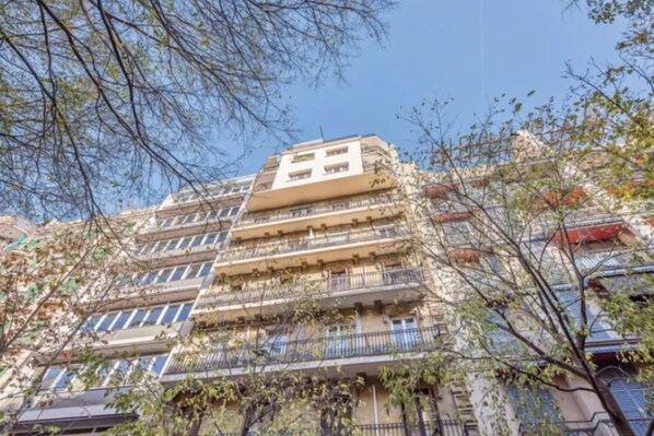 A multi-story building with balconies, likely residential or mixed-use.