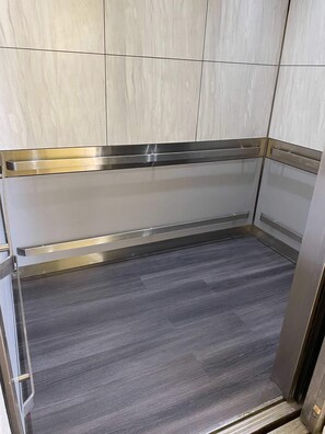 Elevators feature sleek floors and elegant paneling.