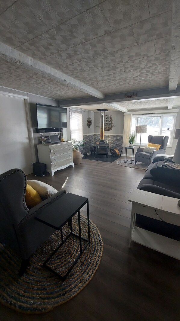 A modern living room with a fireplace, a television, and comfortable seating.