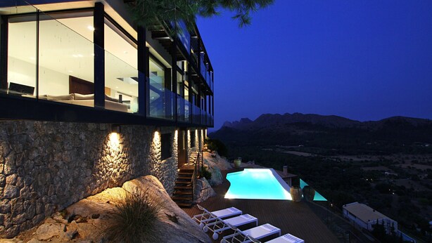 A modern house with a swimming pool, stone walls, and a balcony overlooking a mountainous landscape. - Casa Liebre by Balearic Villas (Pollensa)