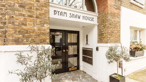 The exterior of a building with a sign reading "BYAM SHAW HOUSE".