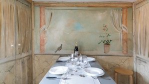 A dining table set for six with wine glasses, plates, and cutlery. - Attico San Marco Top Floor Art 70 mq (Venice)