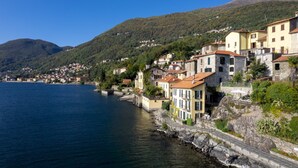 A coastal town with buildings along the waterfront, featuring stone architecture and terraced houses.
