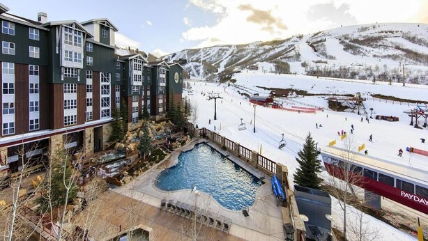 A hotel with a pool, ski slopes, and a mountainous backdrop. - New Year's at Park City Marriott Mountainside -SKI IN SKI OUT (Park City)