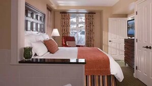 A hotel room with a bed, a nightstand, a lamp, a window with curtains, a dresser, and a television. - New Year's at Park City Marriott Mountainside -SKI IN SKI OUT (Park City)