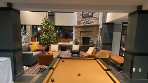 A pool table in a cozy lounge area with a Christmas tree and comfortable seating. - New Year's at Park City Marriott Mountainside -SKI IN SKI OUT (Park City)