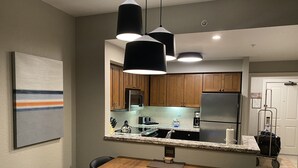 A modern kitchen with wooden cabinets, stainless steel appliances, and a granite countertop. - New Year's at Park City Marriott Mountainside -SKI IN SKI OUT (Park City)
