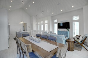 Relax in a spacious living area with a large dining table, comfortable seating, and a cozy sofa set.