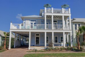 Stunning two-story residence with a spacious balcony and beautifully manicured grounds.