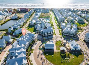 Stunning coastal homes with modern and traditional designs, set amidst well-manicured lawns and a scenic waterfront.