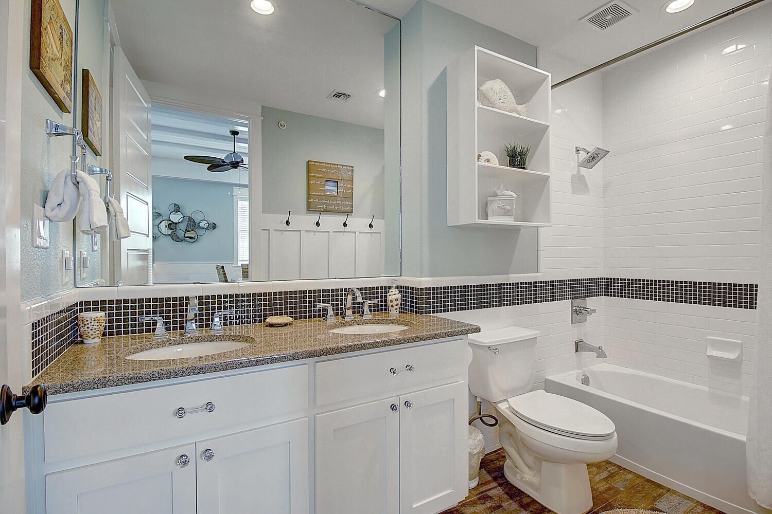 Une salle de bain moderne avec un meuble-lavabo à deux vasques, des carreaux blancs, une baignoire et un espace douche.