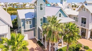 A coastal residential area with houses featuring gabled roofs and a prominent blue building with a tower. - Casa al Mare 237 HI (Port Aransas)