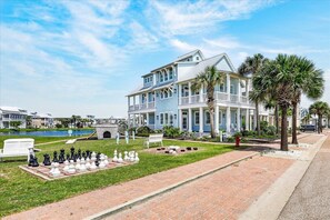 A beachfront property with a large house, a chessboard setup, and a pool. - Sea Ya' 204 GU (Port Aransas)