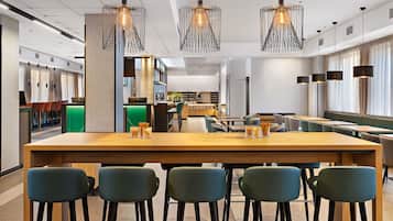 Enjoy a casual dining experience in our inviting space with a long table and comfortable seating for six.