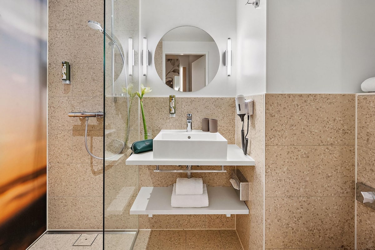 shower, hair dryer, towels, soap